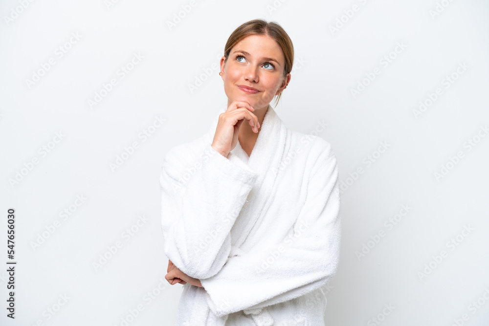 Young pretty blonde woman in bathrobe isolated on white background and looking up Young pretty blonde woman in bathrobe isolated on white background and looking up