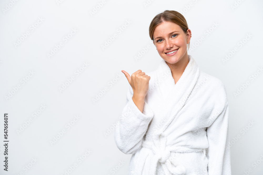 Young pretty blonde woman in bathrobe isolated on white background pointing to the side to present a product Young pretty blonde woman in bathrobe isolated on white background pointing to the side to present a product