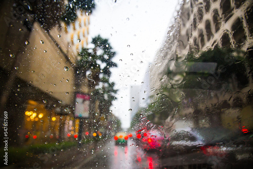 raining drops on the car window in the traffic jam city