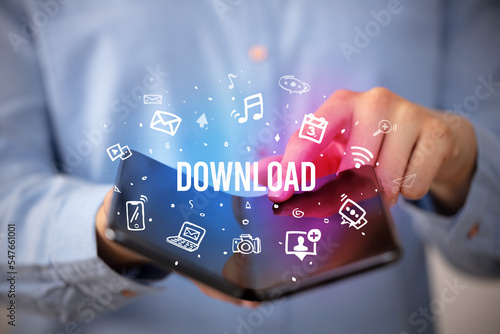 Fotografie Businessman holding a foldable smartphone, social media concept
