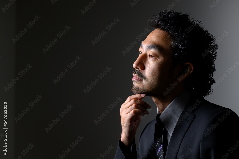 Middle-aged Asian man in a suit that could be used for a bearded beauty or management image. Middle-aged Asian man in a suit that could be used for a bearded beauty or management image.