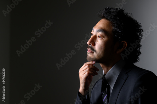 Billede på lærred Middle-aged Asian man in a suit that could be used for a bearded beauty or management image