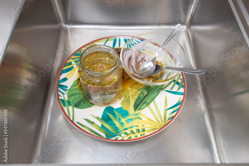 Dirty dishes waiting to be washed in kitchen sink. photo