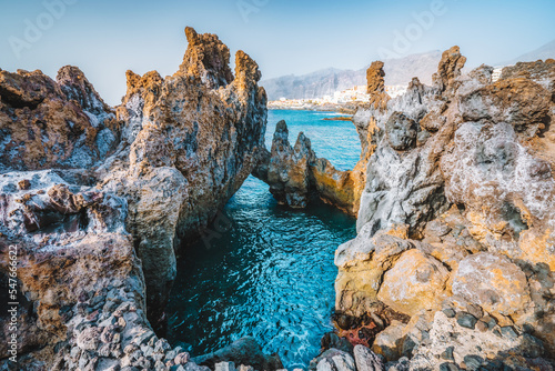 Natural swimming pool. Charco el Diablo, bizarre lava volcanic rock cliffs near to town Puerto de Santiago. Incredibly beautiful turquoise ocean water. Tenerife, Canary island, Spain. photo