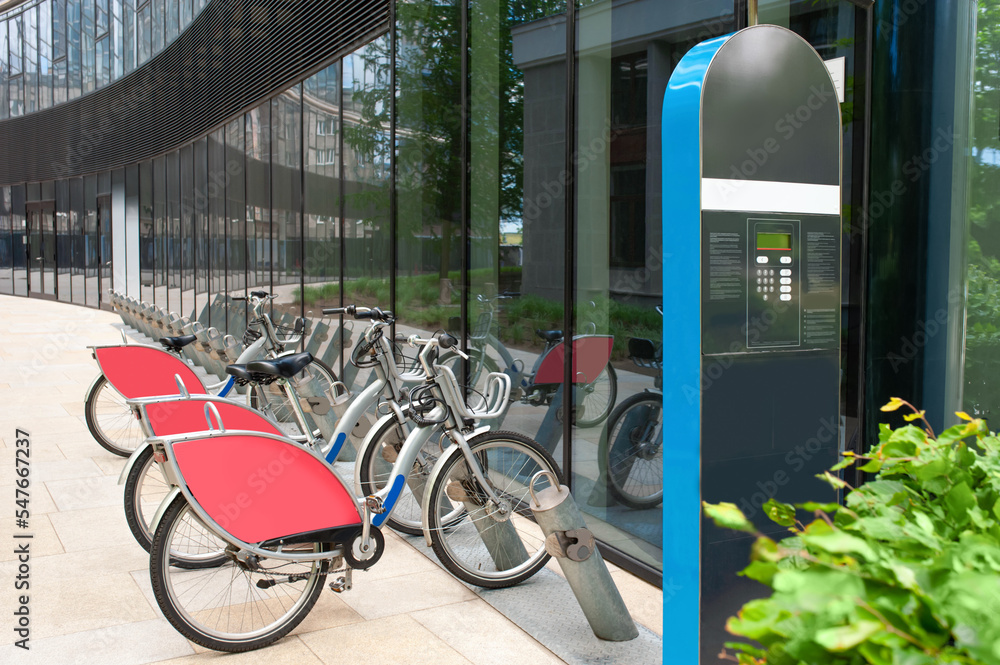 Payment terminal near parking lot with many bicycles outdoors - obrazy, fototapety, plakaty 