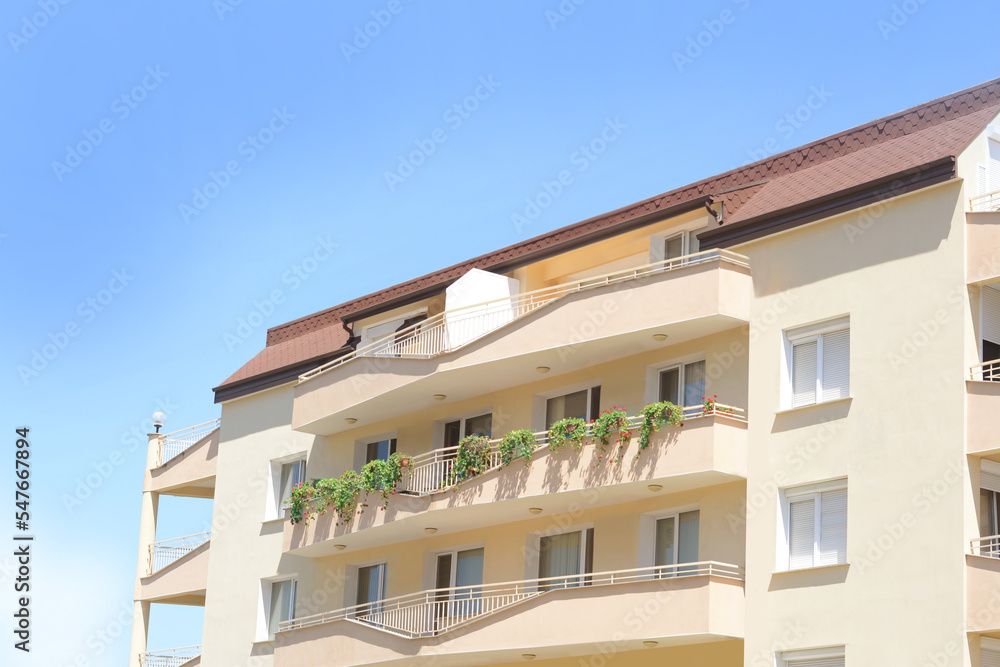 Exterior of beautiful residential building against blue sky Exterior of beautiful residential building against blue sky