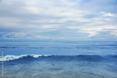 Picturesque view of sea with waves on cloudy day