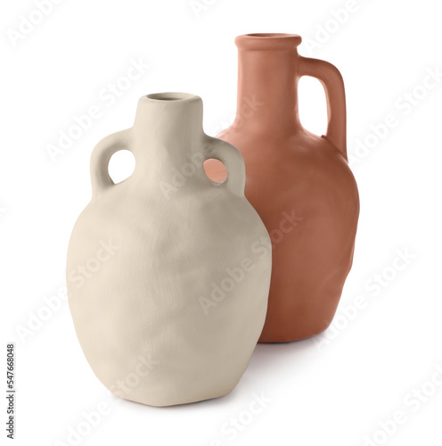 Two clay flagons with handles on white background