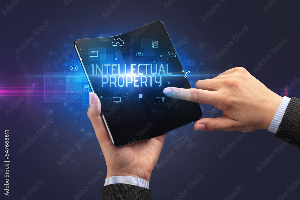 Businessman holding a foldable smartphone, security concept Businessman holding a foldable smartphone, security concept
