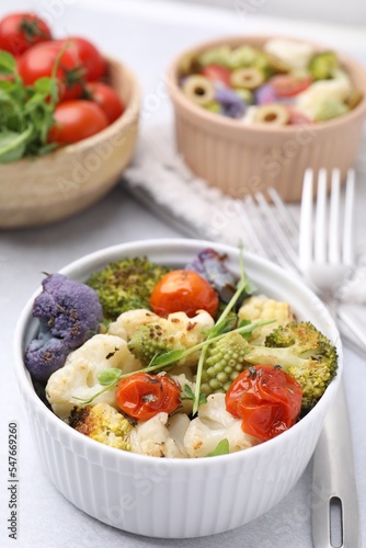 Delicious salad with cauliflower and tomato served on white table