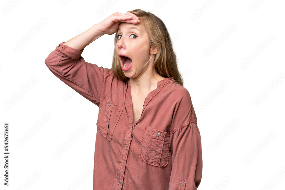 Young blonde woman over isolated background doing surprise gesture while looking to the side Young blonde woman over isolated background doing surprise gesture while looking to the side