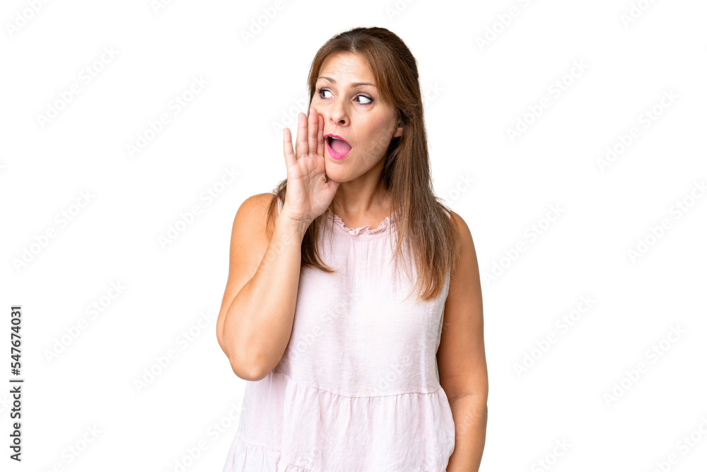 Middle age woman over isolated background whispering something with surprise gesture while looking to the side Middle age woman over isolated background whispering something with surprise gesture while looking to the side