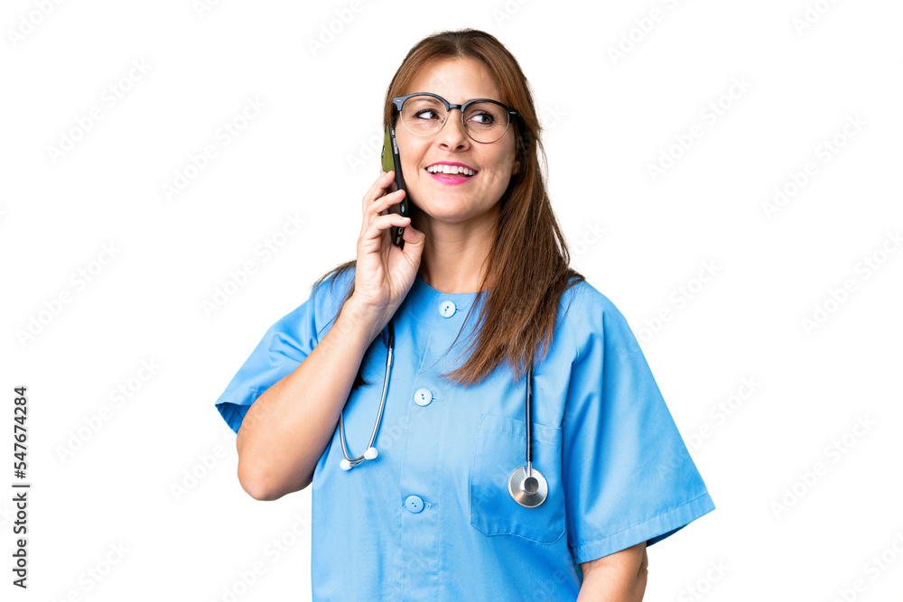 Middle age nurse woman over isolated background keeping a conversation with the mobile phone Middle age nurse woman over isolated background keeping a conversation with the mobile phone