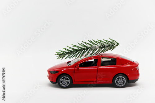 Red car with a sprig of spruce