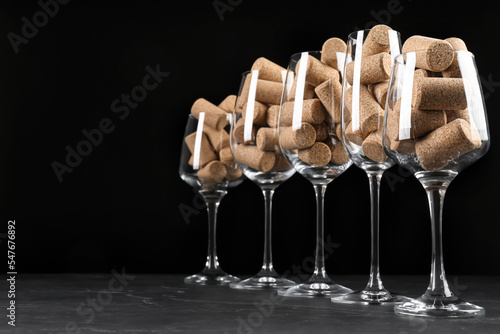 Schilderij op canvas Glasses full of wine corks on black table. Space for text