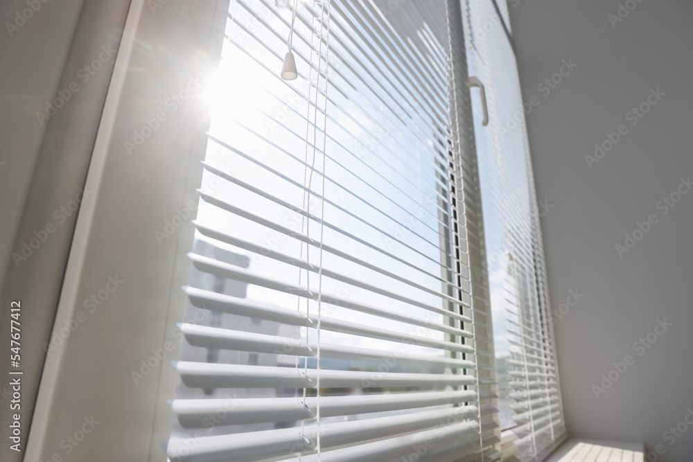 Stylish window with horizontal blinds in room Stylish window with horizontal blinds in room