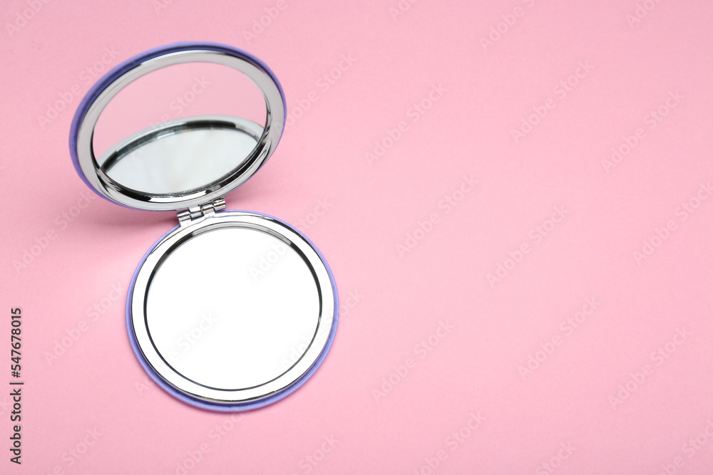 Stylish cosmetic pocket mirror on pink background, top view. Space for text Stylish cosmetic pocket mirror on pink background, top view. Space for text