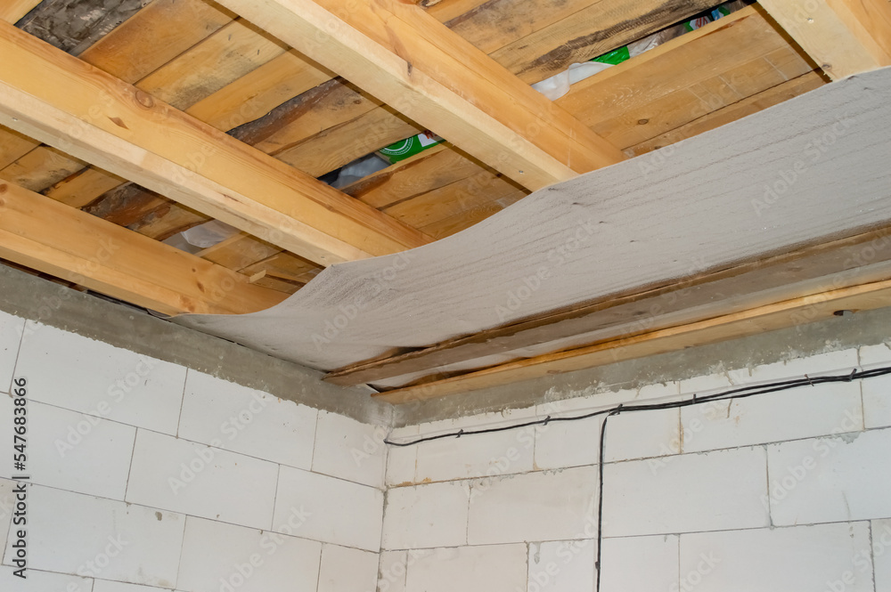 construction of a ceiling from lumber boards and beams, a foil substrate construction of a ceiling from lumber boards and beams, a foil substrate