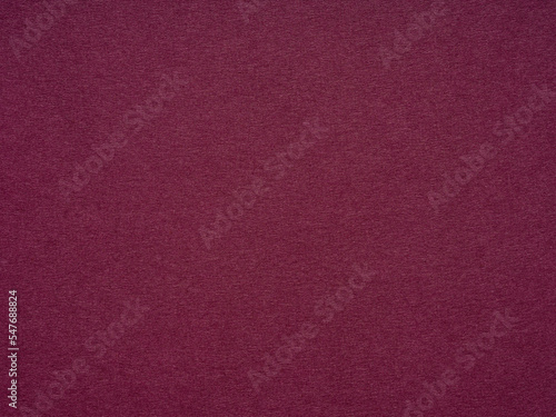 Maroon paper texture, abstract background. The name of the color is burgundy. Blank page sheet decor. Background for handcrafts, new year designs decoration, text, lettering, wall screen saver.