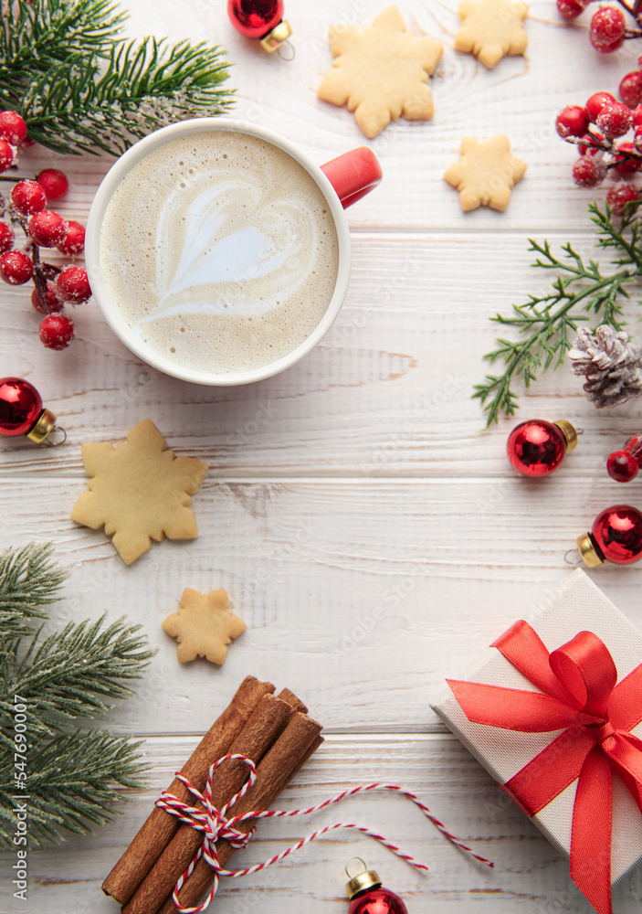 Cup of latte coffee and Christmas decoration on a white wooden background Cup of latte coffee and Christmas decoration on a white wooden background
