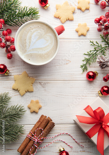Fototapeta Naklejka Na Ścianę i Meble -  Cup of latte coffee and Christmas decoration on a white wooden background