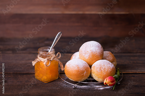homemade donuts for fat thursday with marmalade on a wooden background