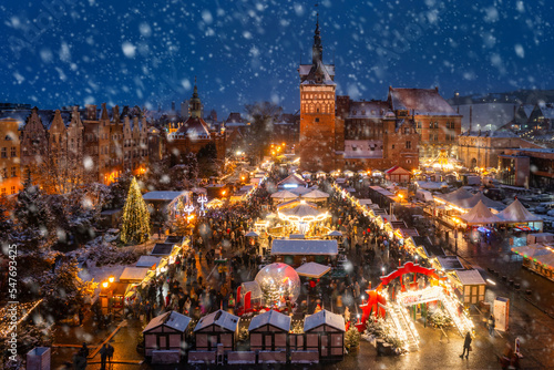 Fotografia Beautifully lit Christmas market in the Main City of Gdansk during a snowfall