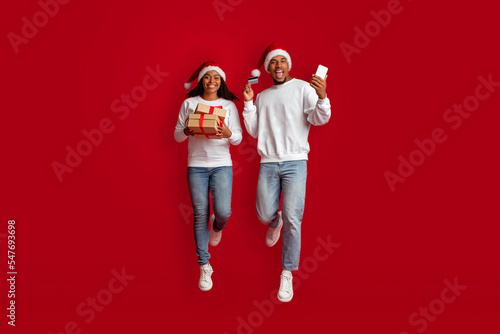 Excited black lovers buying christmas gifts for friends and family