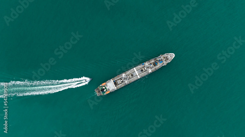 ship floating in middle sea aerial view from drone