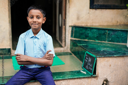 Indian child writing or holding Chalkboard
