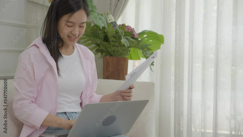 Young asian business woman working on laptop computer and looking graph and chart of report for profit on paper at home, businesswoman looking investment and income, data of infographic statistics. Young asian business woman working on laptop computer and looking graph and chart of report for profit on paper at home, businesswoman looking investment and income, data of infographic statistics.