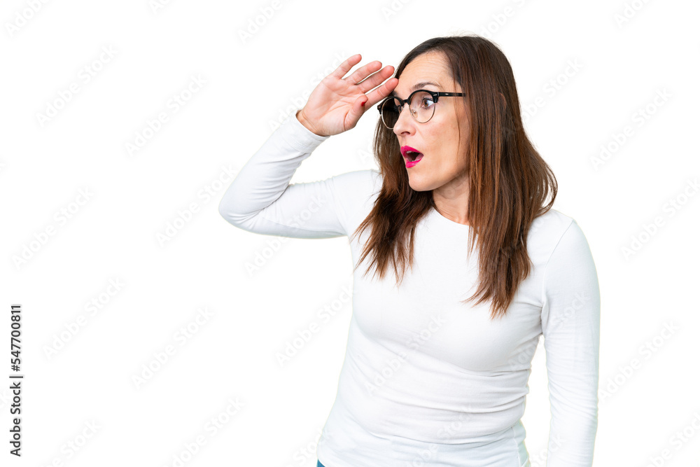 Middle age woman over isolated chroma key background with surprise expression while looking side Middle age woman over isolated chroma key background with surprise expression while looking side