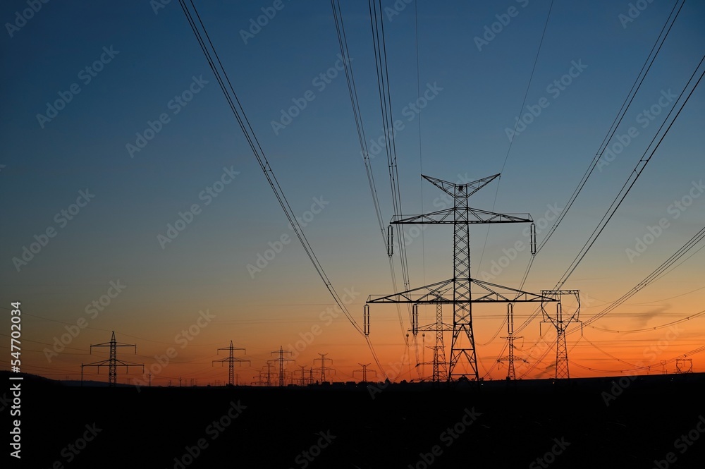 High voltage pylons. Rising energy prices - a concept for industry and energy.. Concept for industry and energy. The crisis in Europe caused by Russian aggression and the war in Ukraine.