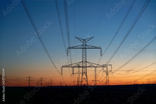 High voltage pylons. Rising energy prices - a concept for industry and energy. Increasing the price of electricity. The crisis in Europe caused by Russian aggression and the war in Ukraine.