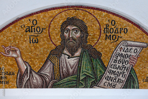 Colourful mosaic hagiography of saint John the Baptist,on the facade above the entrance of the church of the Holy Apostles Peter and Paul in Pefki area in Athens