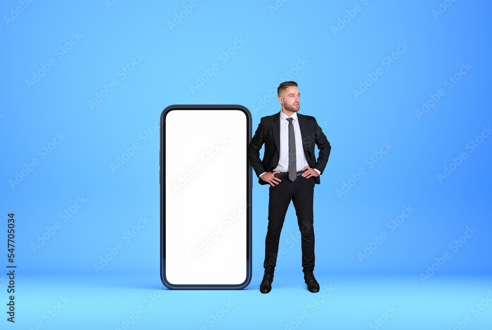Businessman standing in hands on hips pose near smartphone case Businessman standing in hands on hips pose near smartphone case