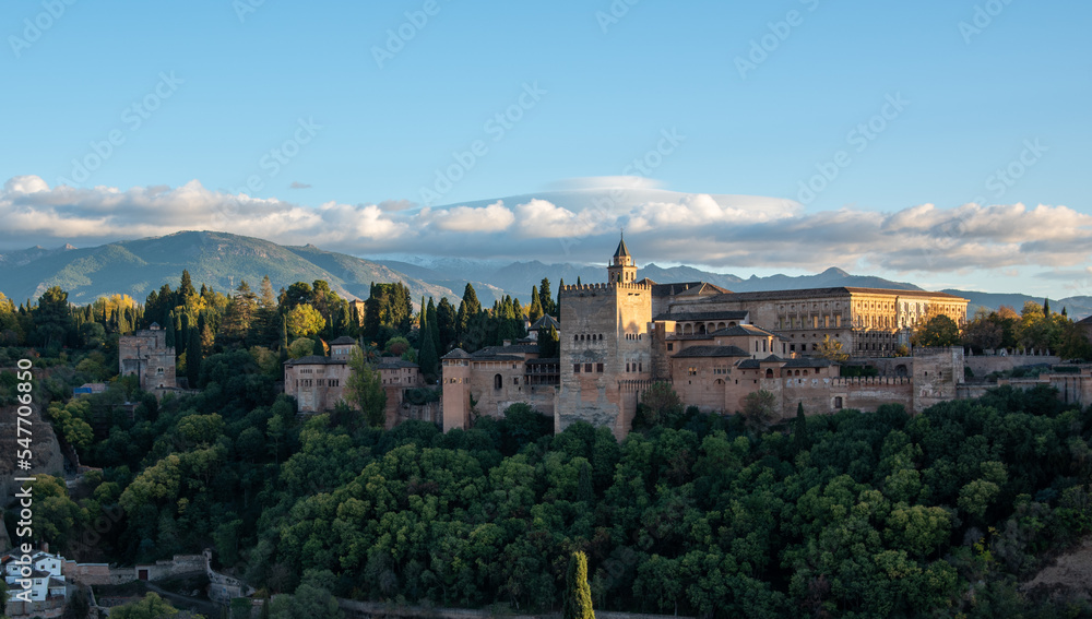 Evening view of the Alhambra palace in Granada, Spain with Sierra Nevada in background