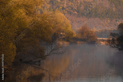 in a misty foggy morning on the river. Bóbr river in the Bóbr valley in the surrondings of Pilchowice in Poland in autumn photo
