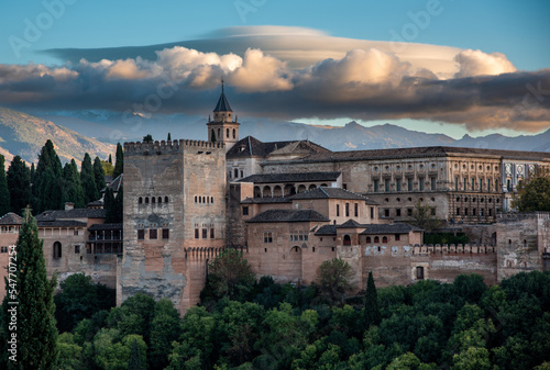 Evening view of the Alhambra palace in Granada, Spain with Sierra Nevada in background