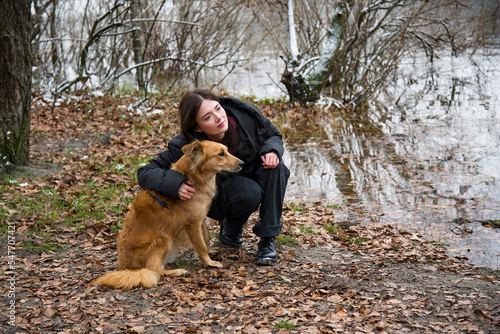 woman hugging dog in winter park © Tetatet