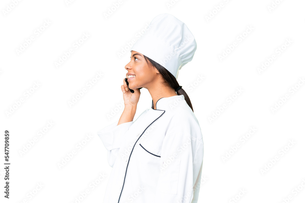 Young African American chef over isolated chroma key background keeping a conversation with the mobile phone with someone Young African American chef over isolated chroma key background keeping a conversation with the mobile phone with someone
