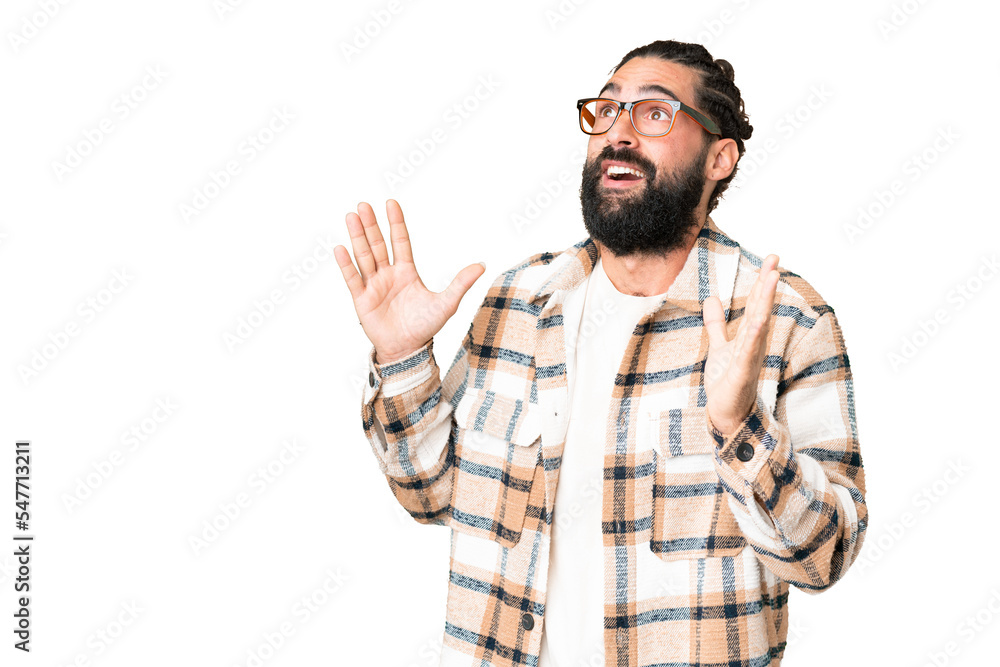 Young man with beard over isolated chroma key background with surprise facial expression Young man with beard over isolated chroma key background with surprise facial expression