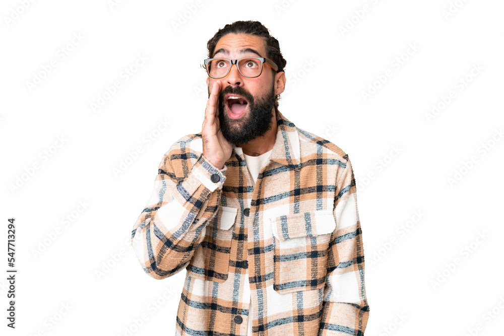 Young man with beard over isolated chroma key background shouting with mouth wide open to the lateral Young man with beard over isolated chroma key background shouting with mouth wide open to the lateral