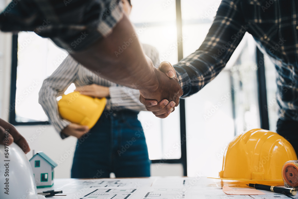 Architect and engineer construction workers shaking hands while working for teamwork and cooperation concept after finish an agreement in the office construction site, success collaboration concept Architect and engineer construction workers shaking hands while working for teamwork and cooperation concept after finish an agreement in the office construction site, success collaboration concept