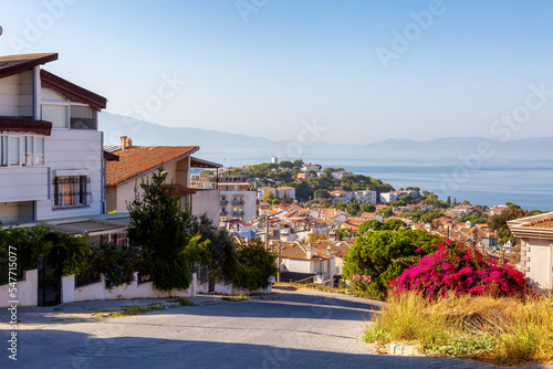 Street in Residential Neighborhood with homes and flowers overlooking Aegean Sea. Kusadasi, Turkey. Sunny Morning.
