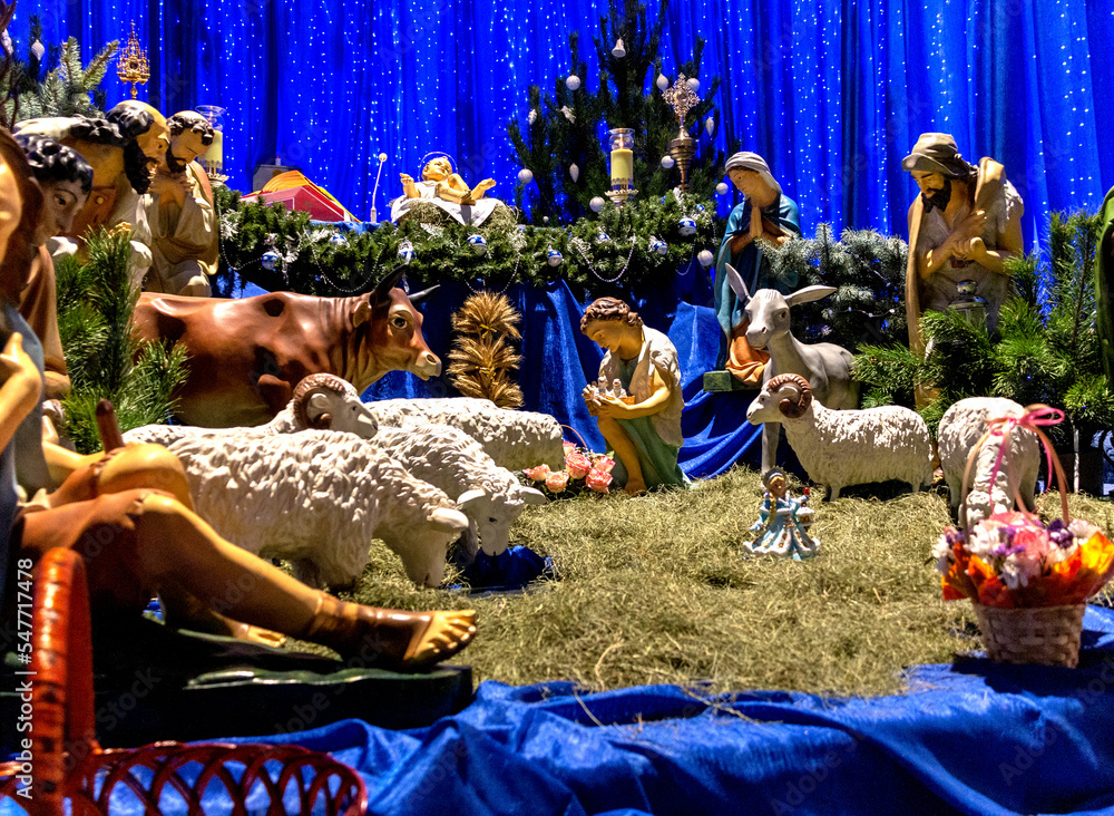 Christmas Nativity scene with The Holy Child, The Blessed Virgin Mary, Saint Joseph, the Magi, sheep, bull and donkey. Nativity of Christ.