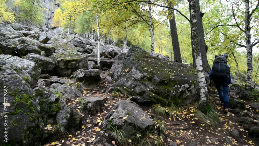 Climbing up the mountain on the rocks. Hiking. Big backpack. Climbing up the mountain on the rocks. Hiking. Big backpack.