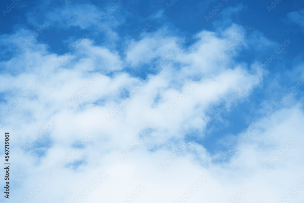 Blurred background. Blue sky and white fluffy clouds.