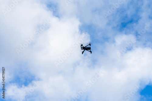 Drone flying in from of a clouds sky