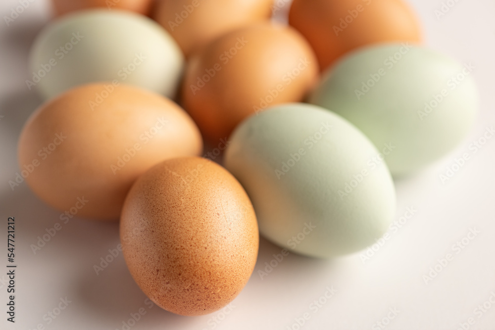 Closeup of green and brown raw, organic eggs Closeup of green and brown raw, organic eggs
